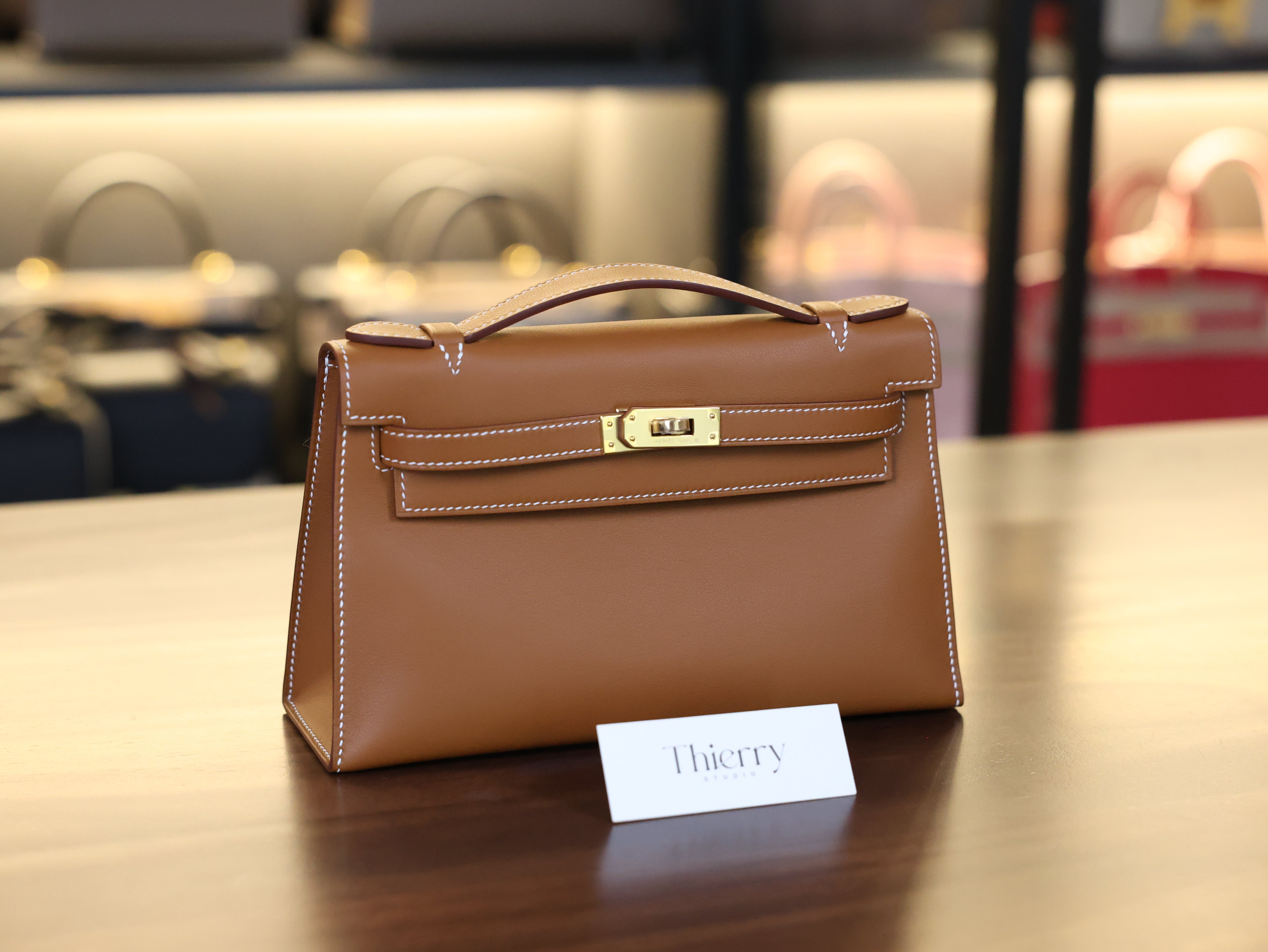 Kelly pochette swift gold GHW